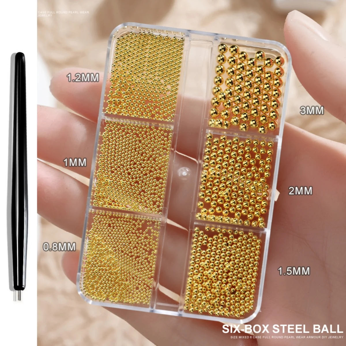 A clear box holds various sizes of gold mixed stainless steel beads for nail art decorations.