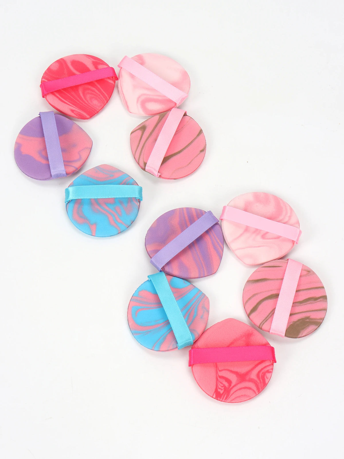 A set of six pink and purple air cushion beauty puffs with pink and purple accents.