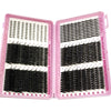 A pink plastic kit containing multiple sets of black false eyelashes for DIY lash extensions.
