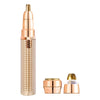 A gold-toned electric facial and body hair remover device shown with its components.