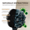 A dark blue silicone body brush with a textured head is shown next to green bacteria-like illustrations.
