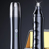 A sleek black electric nose and ear trimmer is shown on a device base.