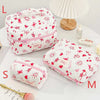 Pink and white quilted cotton makeup bags in various sizes L, S, M, and M, with a lamp in the background.
