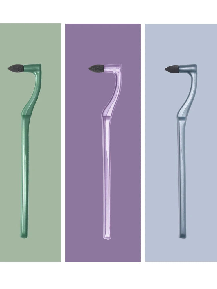 Three versions of a manual tooth stain remover with an interdental brush in green, purple, and silver.