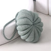 A light gray exfoliating bath bubble ball made of soft mesh sponge with a braided cord.