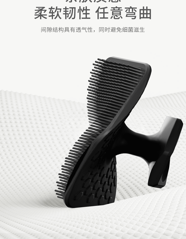 A black silicone facial cleaning brush is shown against a white textured background.