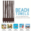 Un juego de toallas de playa con rayas verticales negras y blancas, con opciones para picnic, yoga, natación, playa y viaje