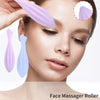 A woman is using a silicone face massager roller in various shades of purple and blue for facial massage.
