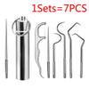A set of seven reusable aluminum toothpicks and a holder for oral cleaning.