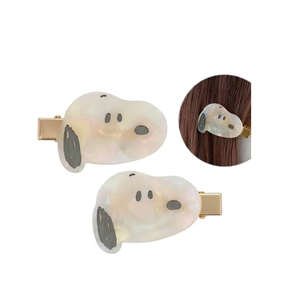 A set of two hair clips shaped like Snoopy cartoon faces made of translucent white and gray mother-of-pearl.