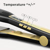 Close-up of a black flat iron hair straightener showing temperature controls marked with plus and minus symbols.