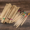 A collection of eco-friendly bamboo toothbrushes in various colors and natural wood tones.