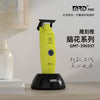 A yellow MRD Pro electric hair clipper with a black base and a cutting guard is displayed on a light wooden surface.