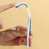 A hand holds a white and blue silicone tongue scraper, demonstrating its shape for oral hygiene.