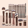 A set of professional makeup brushes in various sizes and shades for foundation and eyeshadow application.
