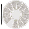 A circular plate of mixed stainless steel beads used for nail art decorations, with a black tool next to it.