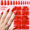 A hand displays a collection of 120 press-on nails in various red shades and sizes.