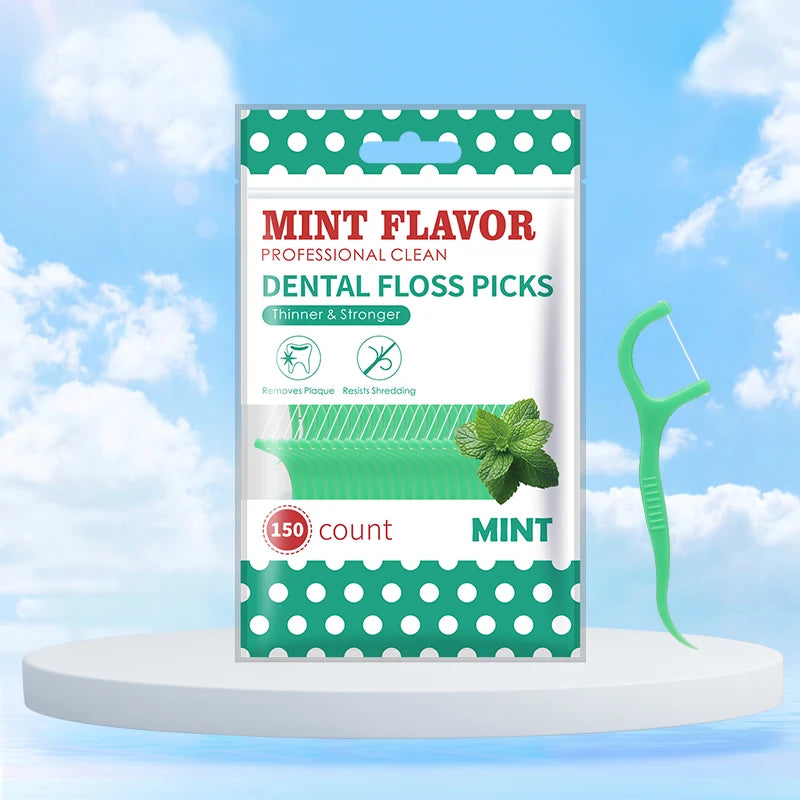 Une boîte de ficelle dentaire professionnelle au goût menthe avec un flosser en plastique vert visible à côté.