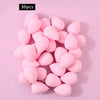 A set of 30 pink, oval-shaped soft makeup sponges arranged on a light pink background.