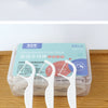 A clear plastic container holds several white orthodontic floss sticks for dental cleaning.