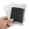 A hand holds a clear plastic package containing disposable black micro brushes for eyelash extensions.