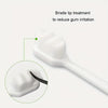 A white toothbrush with a bristle tip is shown next to a magnified view of the soft bristles for gum treatment.