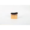 A small wooden brush with dark bristles used for applying tan and foundation.