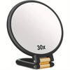A black magnifying mirror with a 30x magnification lens and a gold-colored handle.