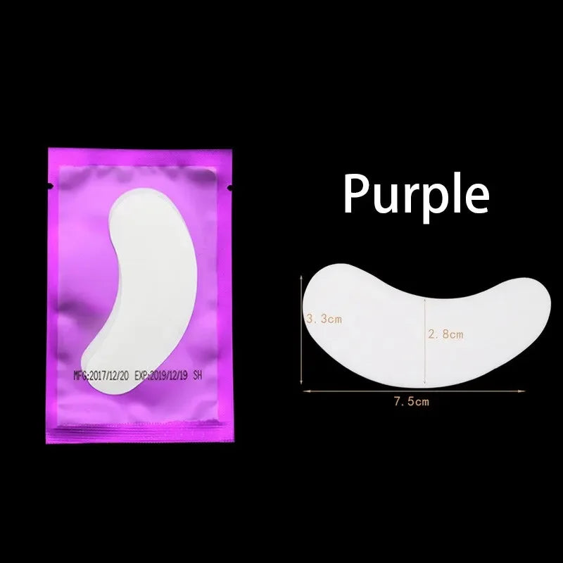 Purple under-eye lash application patches shown on a clear backing.