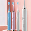 A display of four smart electric toothbrushes in blue, pink, and white against a light background.