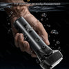 A hand holds a black portable electric shaver, demonstrating its fully washable design.