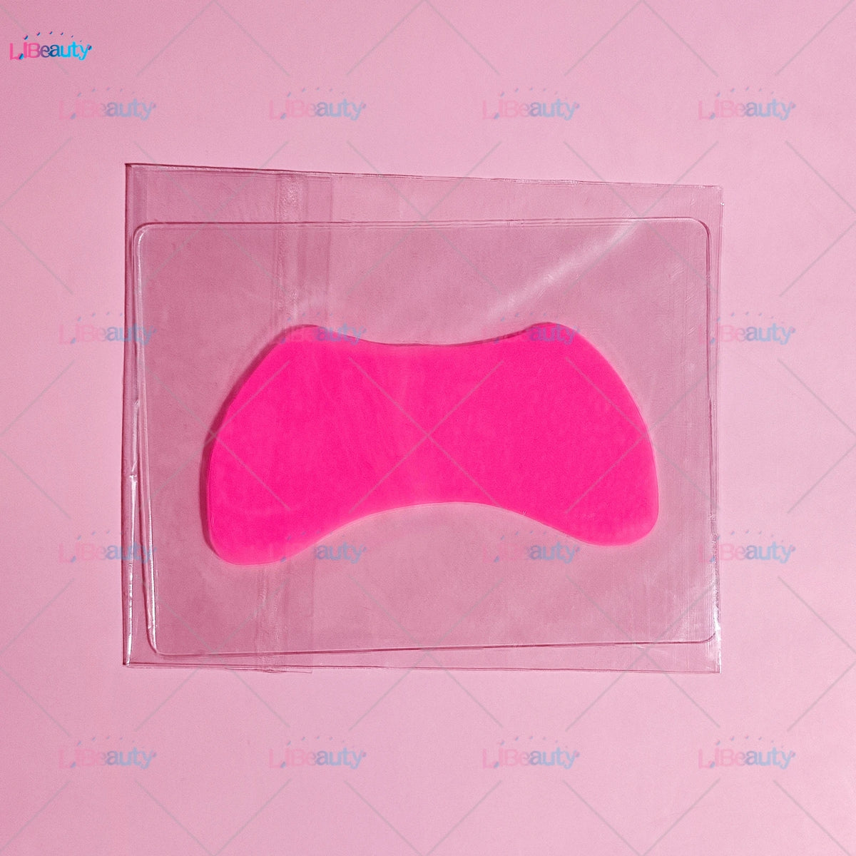 A pink silicone lash lift shield eye pad is sealed in a clear plastic pouch.