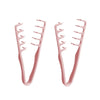 A pair of rose gold volumizing wide-tooth hair styling combs.