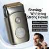 A close-up of a metallic electric shaver with a power indicator display and a man using it.