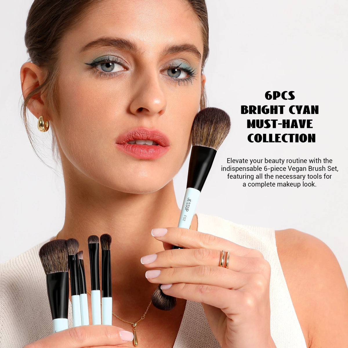 A woman holds a 6-piece bright cyan must-have vegan brush set for makeup application.