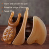 A set of smooth, translucent amber-colored facial tools for massage and lifting.