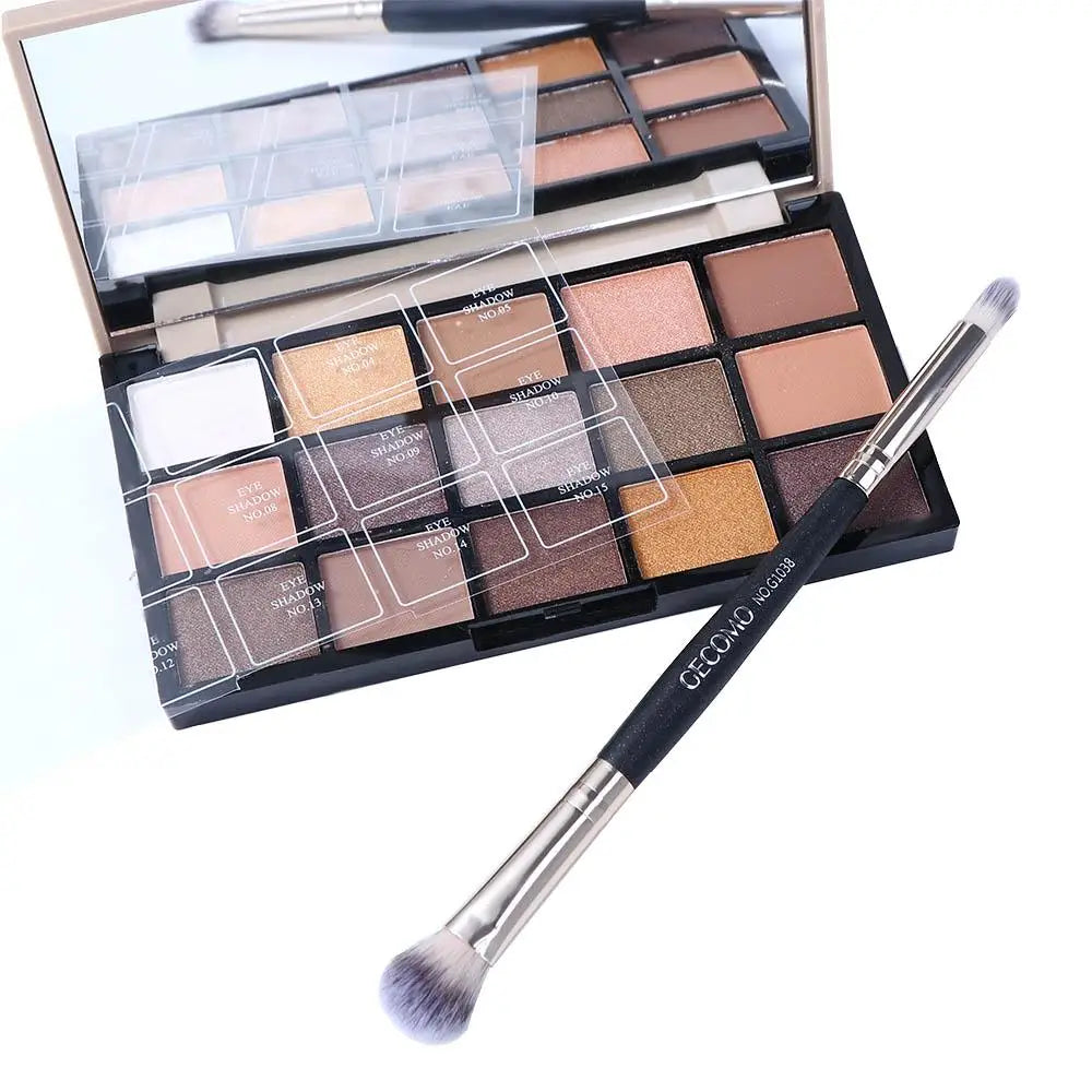 A double-ended eye shadow brush with a smudge tip and blending shader is shown in an open makeup palette.