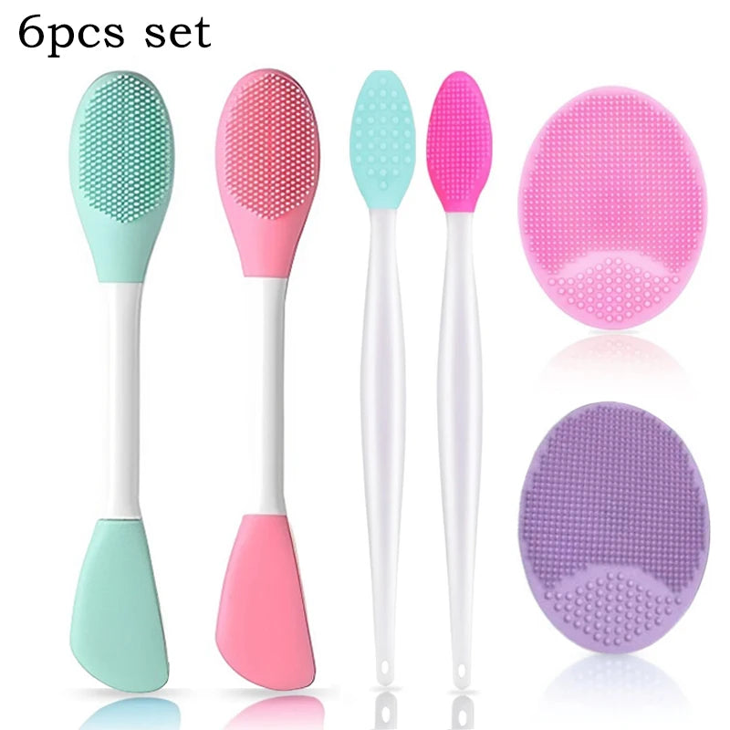 A set of six silicone facial cleansing brushes and mask applicators in various shades of pink and green.