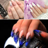 Close-up of hands displaying various acrylic nail designs and glitter powders on nails