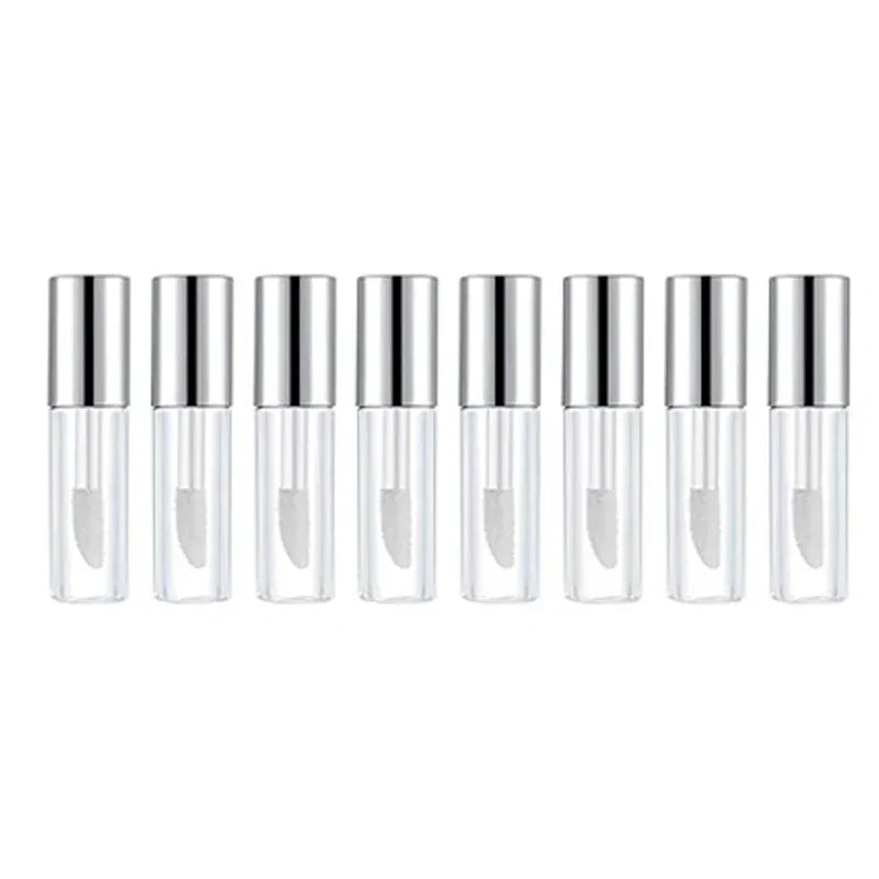 A row of ten clear glass lip gloss tubes with silver caps, used as mini empty containers for DIY cosmetics.