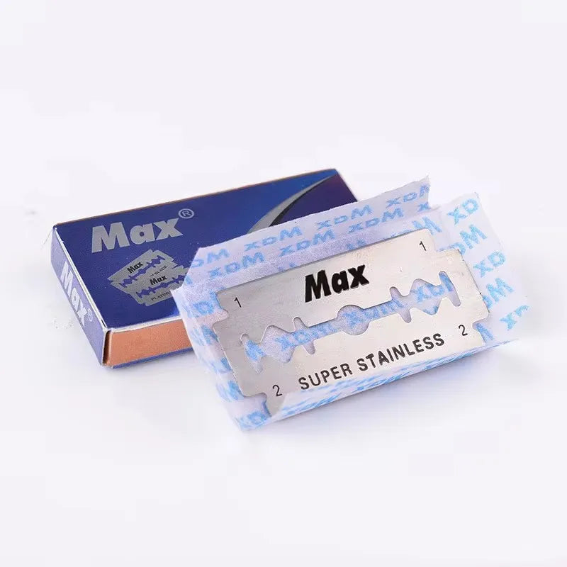 A set of Max super stainless steel double-sided razor blades packaged in a blue box and clear plastic.