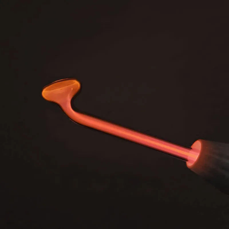 A close-up of a high-frequency skin rejuvenation wand with an orange tip against a dark background.