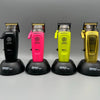 Four electric hair clippers in black, pink, lime green, and gold displayed side by side.