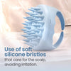 A light blue scalp massager shampoo brush with soft silicone bristles shown on a white surface.