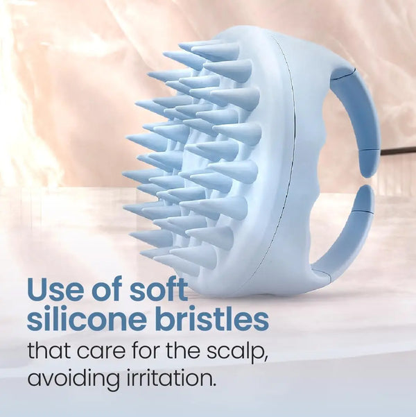 A light blue scalp massager shampoo brush with soft silicone bristles shown on a white surface.