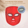 A red facial mask with LED light irradiation design, showing a close-up of the lens structure.
