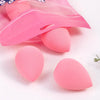 A pink beauty egg puff product with six individual puffs visible on a white surface.