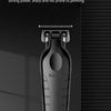 A black salon level electric scissor is displayed vertically on a white marble stand.