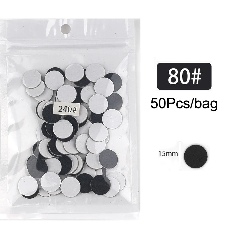 Sac en plastique transparent contenant 50 disques de papier de verre noir et blanc, avec une règle de mesure de 15 mm.