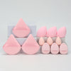 A set of 12 pink makeup sponges in various shapes and sizes displayed on a white surface.